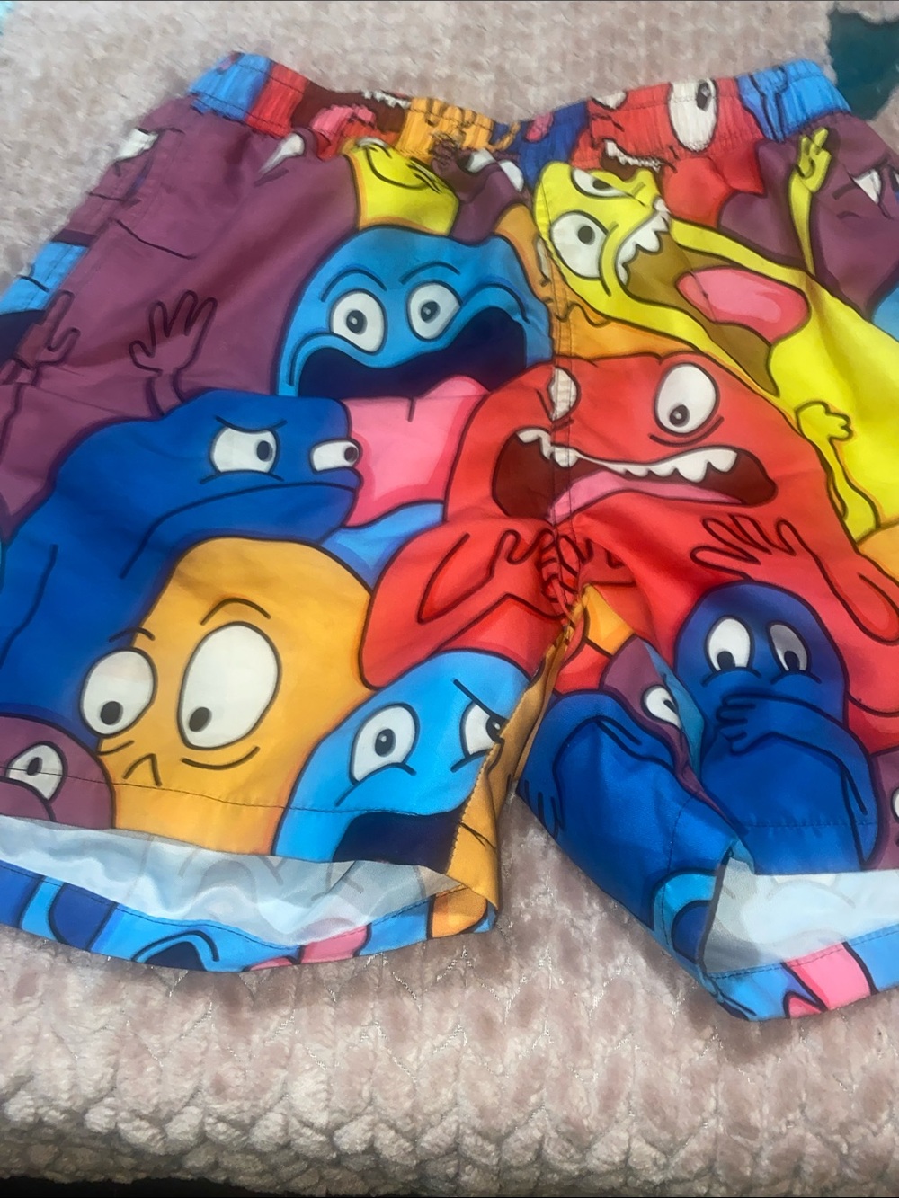 Rainbow swim trunks with colorful monsters